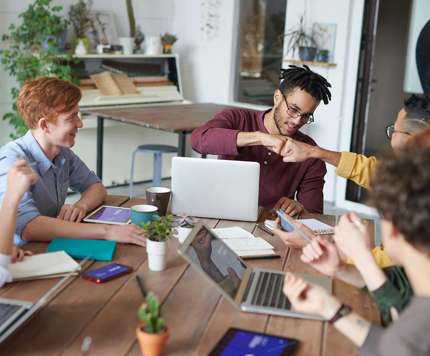 Employees collaborating around a table in the workplace